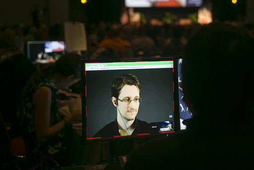 A video technician monitors a computer screen as Edward Snowden appears on a live video feed broadcast from Moscow at an event sponsored by the ACLU Hawaii in Honolulu on Feb. 14 2015