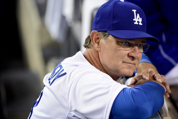 Manager Don Mattingly #8 of the Los Angeles Dodgers in the dugout before the game against the Arizona Diamondbacks at Dodger Stadium