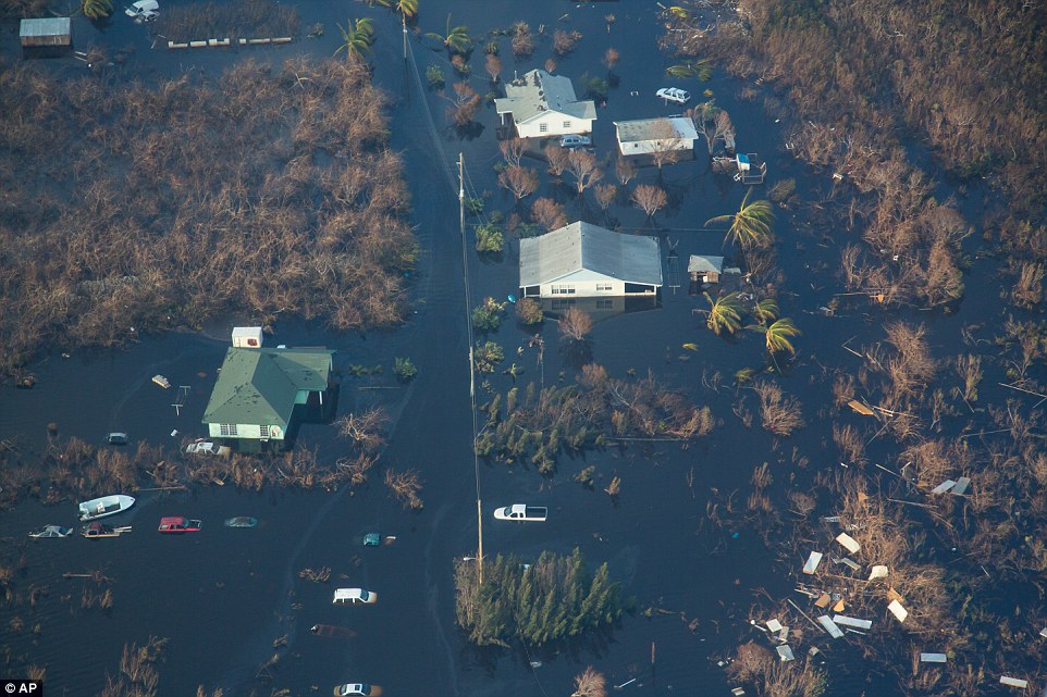 Devastated The tops of cars and house roofs sit above the surface of the rising floodwaters in Long Island Bahamas after Hurricane Joaquin inflected storms on the archipelagos