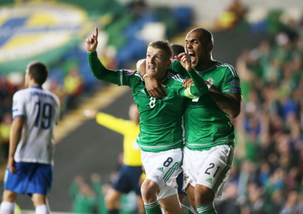 Steven Davis celebrates with fellow goalscorer Josh Magennis