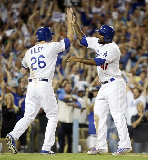 Los Angeles Dodgers&#039 Chase Utley left and Howie Kendrick celebrates after scoring on a hit by Adrian Gonzalez during the seventh inning in Game 2 of baseball's National League Division Series against the New York Mets Saturday Oct. 10 2015