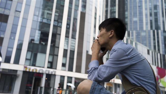 A man smokes a cigarette in Beijing