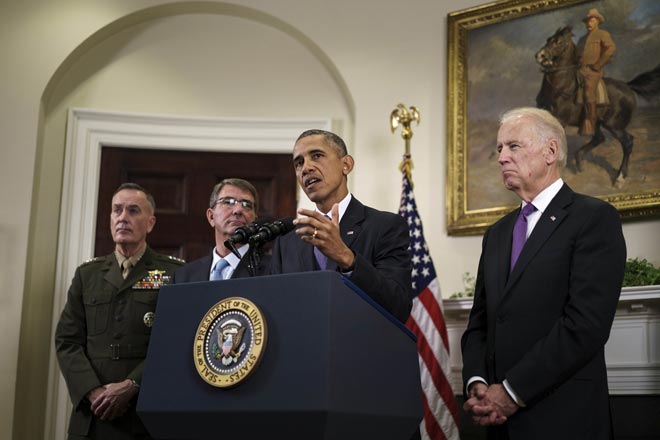 Chairman of the Joint Chiefs of Staff Marine General Joseph F Dunford US Secretary of Defense Ashton Carter and US Vice President Joe R Biden listen while Obama makes a statement in the Rosevelt Room of the White House in Washington