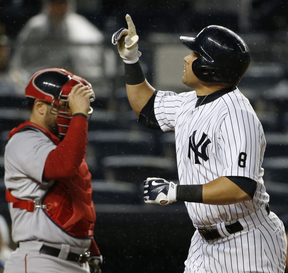 New York Yankees Carlos Beltran right points skyward as he crosses the plate after hitting a second-inning solo home run off Boston Red Sox starting pitcher Rich Hill in a baseball game in New York Thursday Oct. 1 2015. Red Sox catcher Sandy Leon