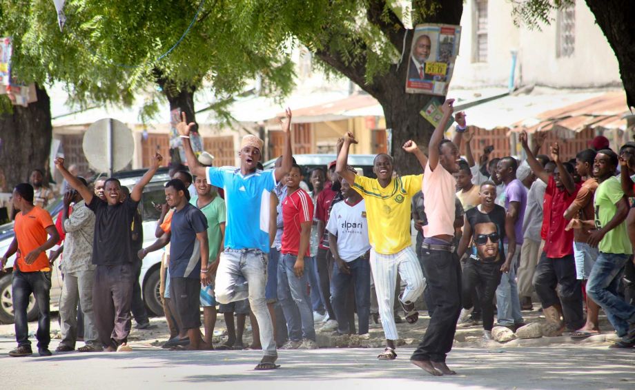 26th 2015 and made available Wednesday Oct. 28th 2015 youths supporting the opposition party dance and chant predicting a win for their candidate outside the Electoral Commission office in Stone Town Zanzibar a sem