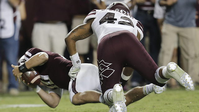 Kyle Allen #10 of the Texas A&M Aggies is tackled by Beniquez Brown #42 of the Mississippi State Bulldogs on the goal line in the second quarter