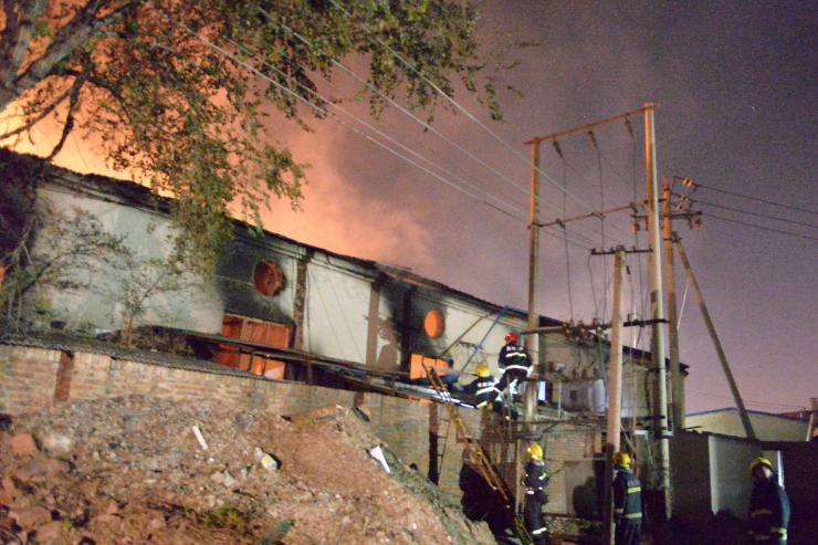 Fire and smoke rise at the site of an explosion at a warehouse in in Tianjin China