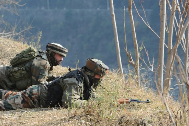 Indian soldiers overlook army barracks after an attack by militants in Gingal Uri some 90 kms north of Srinagar in Jammu and Kashmir