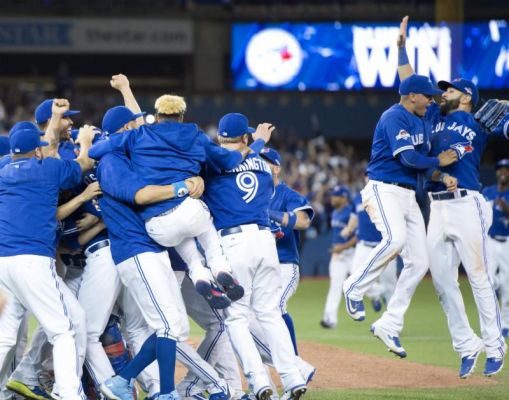 The Toronto Blue Jays celebrate after winning Game