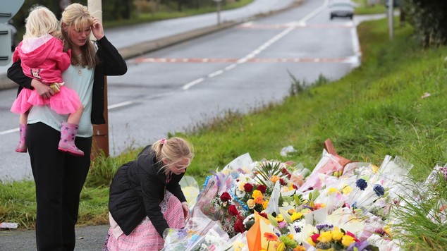 Pc David Phillips's wife Jen and daughters Abigail and Sophie visit the scene in Wallasey where the Merseyside officer was mown down and killed by a stolen car