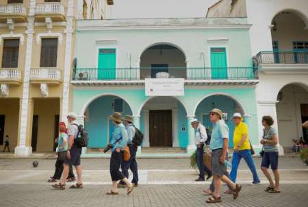 Tourists walk along a street of Old Havana