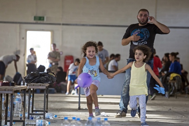 Syrian migrants are temporarily housed at a warehouse after coming ashore at RAF base Akrotiri Cyprus Oct. 21