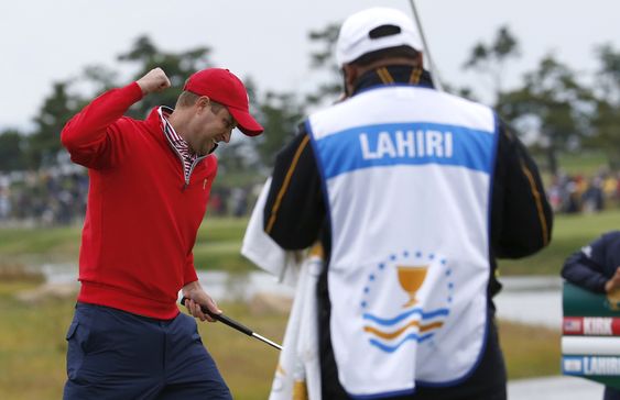 Kirk left celebrates after sinking a putt on the 18th green to defeat International team player Anirban Lahiri of India 1up in their singles match at the Presidents Cup golf tournament at the Jack Nicklaus Golf Club Korea