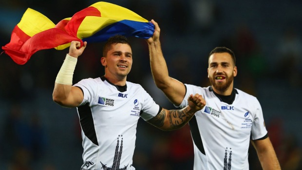 Valentin Calafeteanu and Madalin Lemnaru of Romania celebrate their victory over Canada at Leicester City Stadium on Tuesday