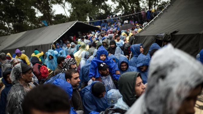 Migrants wait to enter Croatia as they wait near the western Serbian border village of Berkasovo