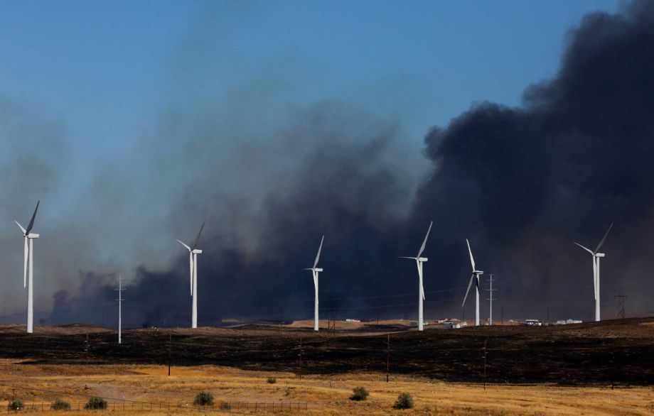 Heavy smoke rises from a wildfire east of Evansville Wyo. Monday Oct. 12 2015. The fast-moving grass fire that started at a landfill destroyed an unknown number of homes and other buildings and forced hundreds of people to evacuate from a rural area