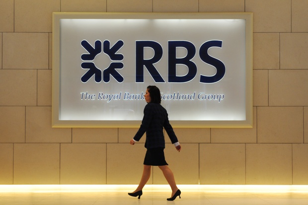 Woman walking past RBS sign
Facundo Arrizabalaga