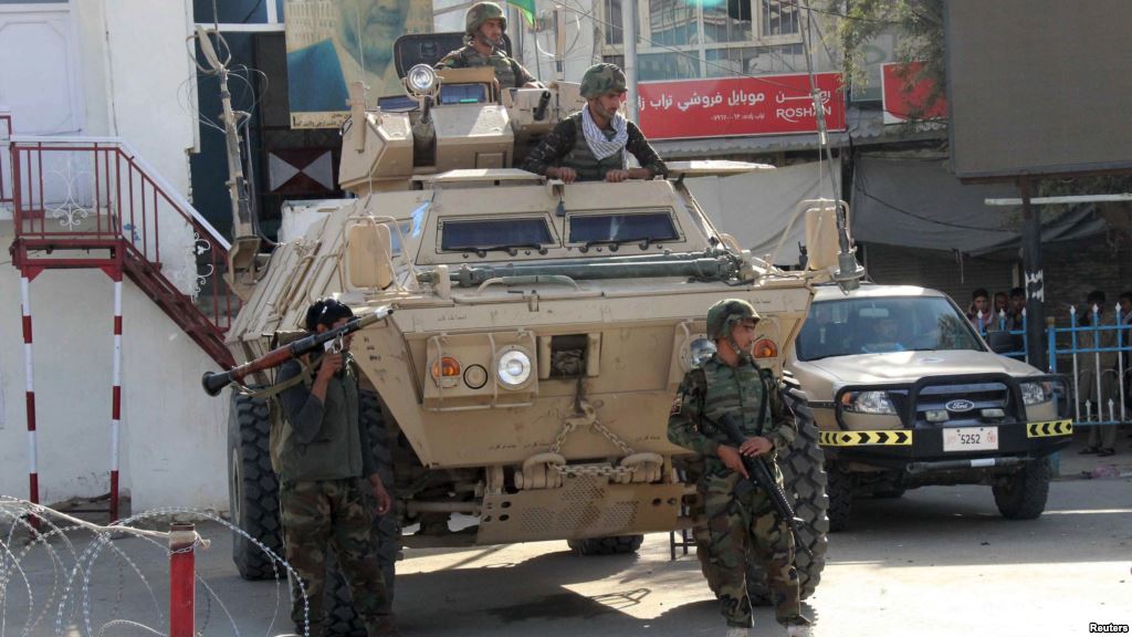 Afghan soldiers keep watch during a battle with the Taliban in Kunduz in northern Afghanistan on September 28