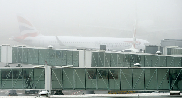 A British Airways plane in the fog at Terminal 5 of Heathrow Airport today. Pic PA