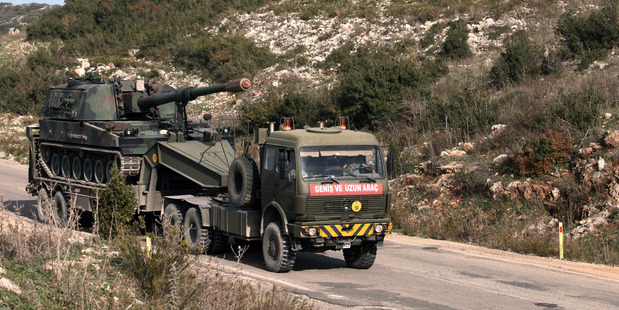A Turkish army truck loaded with a self-propelled gun heading to the Syrian border near Yayladagi Turkey