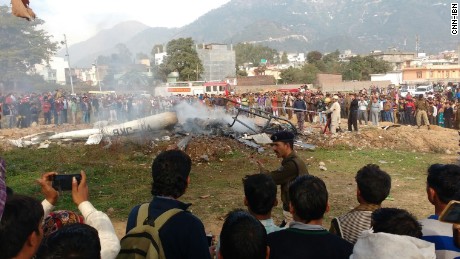 A crowd gathered at the scene of the deadly helicopter crash in Katra Kashmir on Monday