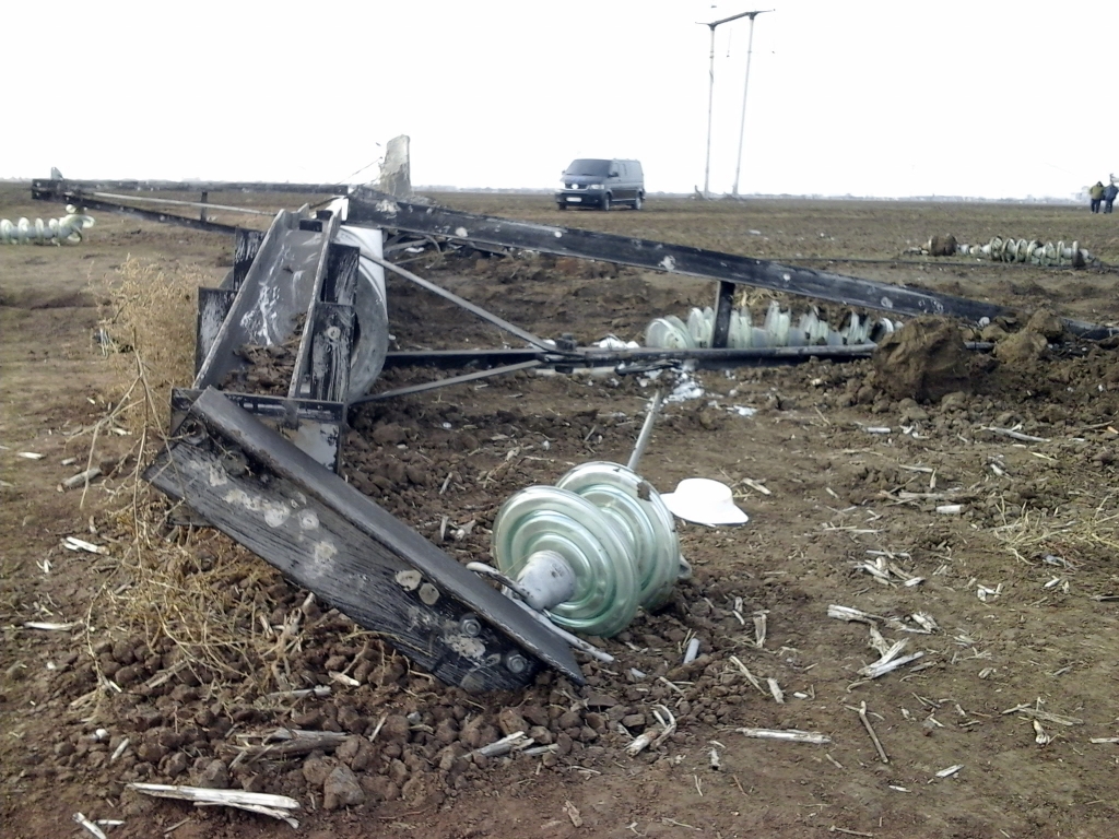 A damaged transmission tower lays on the ground close to the village of Chaplinka on the Crimean border