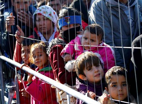 A group of migrants waits to cross the border from the village of Sentilj Slovenia into Spielfeld in Austria