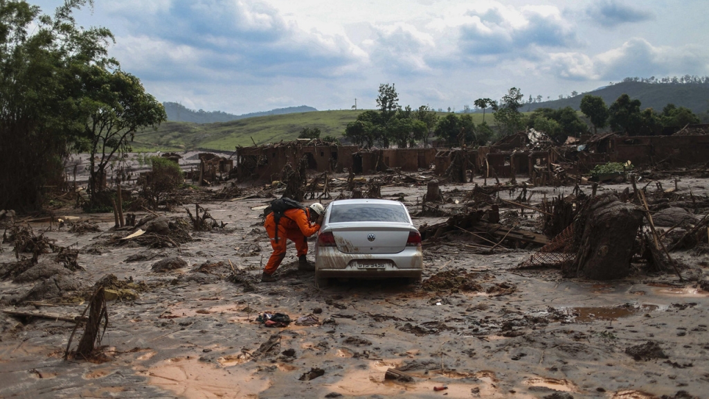 A second death has been confirmed and 28 people are still missing after a mine dam burst in Brazil