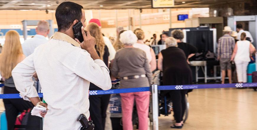 A security officer talks on his phone in front of the luggage screening section at the airport of Sharm El Sheikh Egypt Saturday