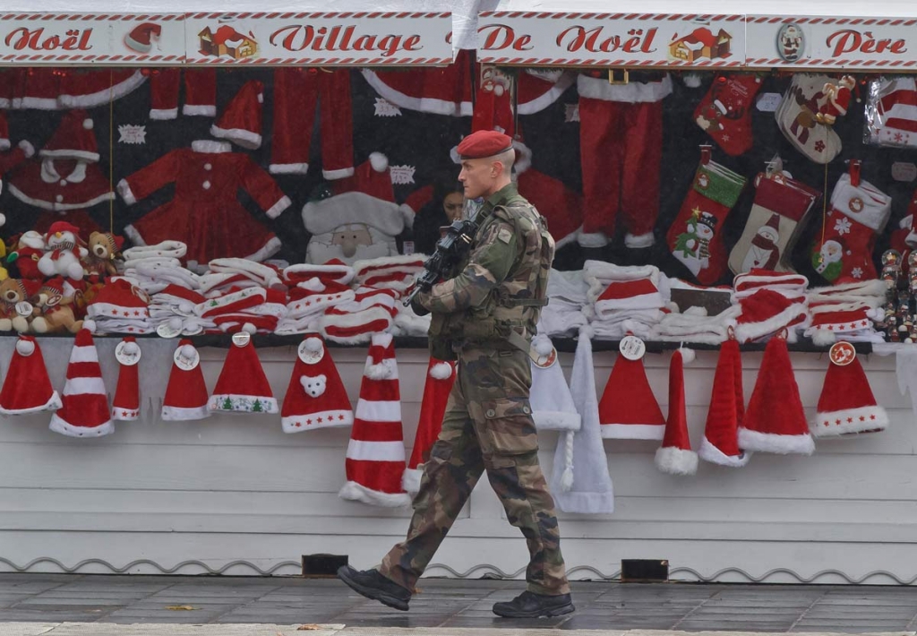 A soldiers patrols at the Christmas market along the Champs Elysees avenue in Paris Tuesday Nov. 24 2015