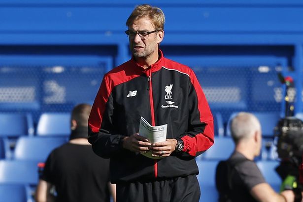 Jurgen Klopp inspects the Stamford Bridge pitch ahead of the match