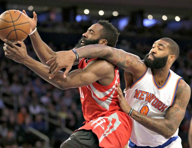 Knicks&#39 Kyle O'Quinn right fouls Houston Rockets&#39 James Harden during the first half Sunday