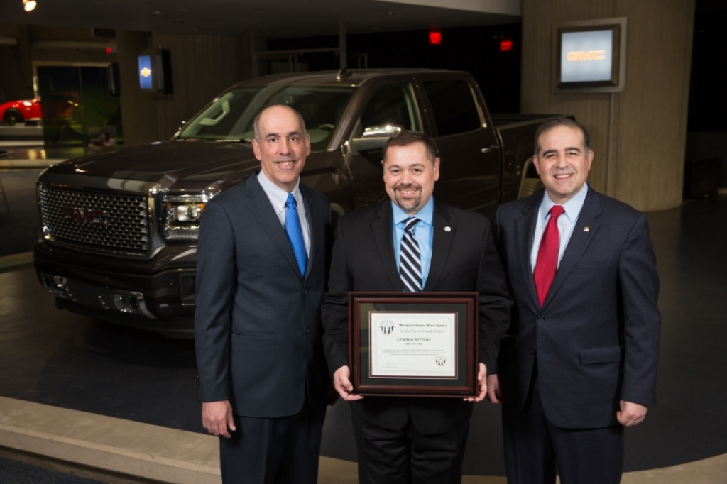 Michigan Veterans Affairs Agency Director Jeff Barnes presents the first-ever Gold Level Veteran-Friendly Employer Award to General Motors Vice President of U.S. Sales and Service Steve Hill and GM Chief Diversity Officer Ken Barrett to