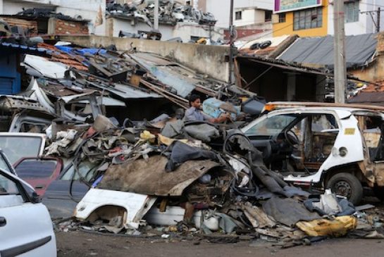 23 2015 an Indian worker dismantles an old car amid heaps of scrap in Bangalore India