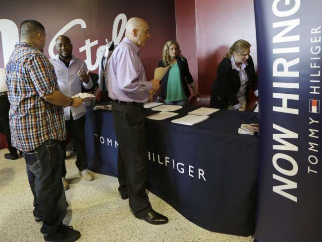 Job seekers attend an employment fair in Sunrise Fla. in June