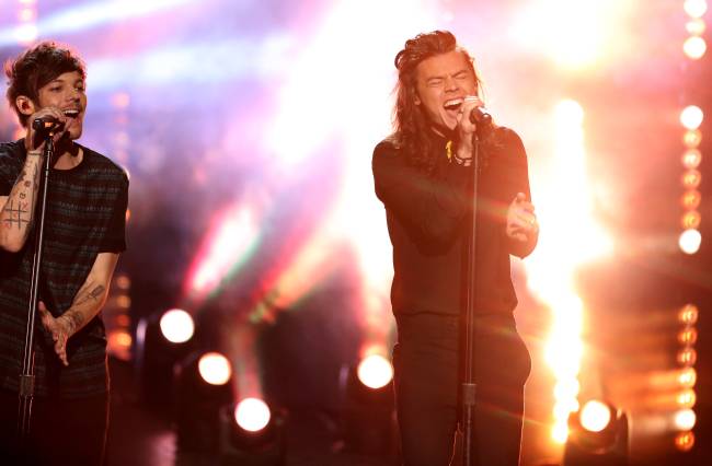 Louis Tomlinson left and Harry Styles of One Direction perform at the American Music Awards at the Microsoft Theater on Sunday Nov. 22 2015 in Los Angeles