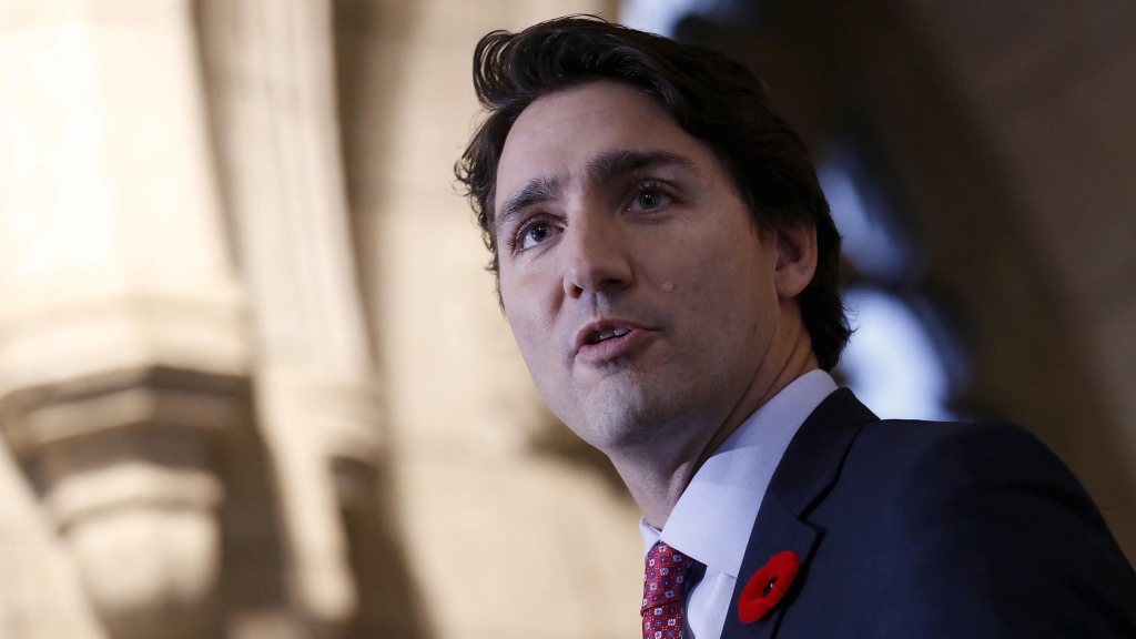 Canada's Prime Minister Justin Trudeau speaks to journalists as he arrives for a Liberal caucus meeting on Parliament Hill in Ottawa Canada