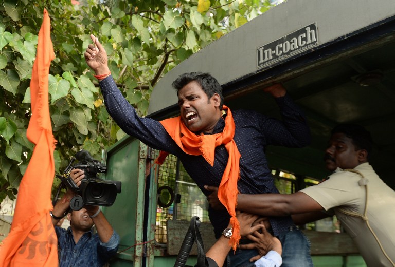 An Indian activist shouts slogans as he is detained by police outside the home of Bollywood actor Aamir Khan in Mumbai