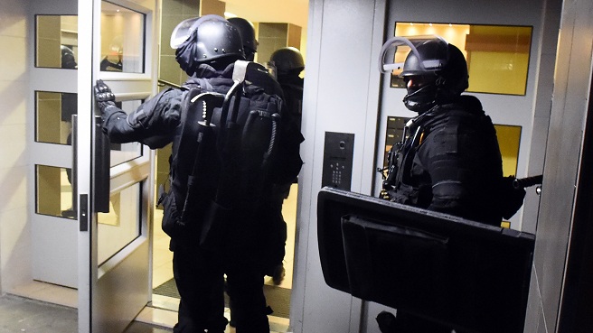 Anti terrorism police officers enter a building during a raid in the Mirail district in Toulouse southwestern France Monday Nov. 16 2015