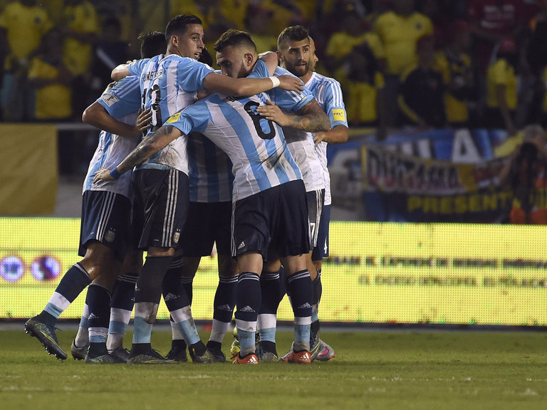 Argentina's players celebrate after defeating Colombia 1-0