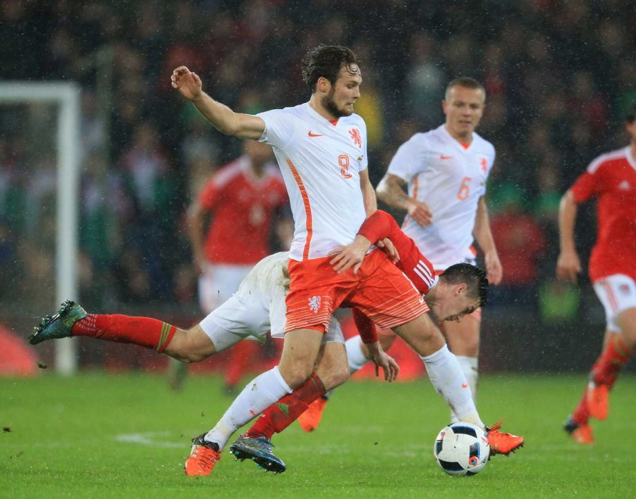 Wales Tom Lawrence rear and Netherlands Daley Blind battle for the ball during an international friendly soccer match at the Cardiff City Stadium Cardiff Wales Friday Nov. 13 2015. UNITED KINGDOM OUT