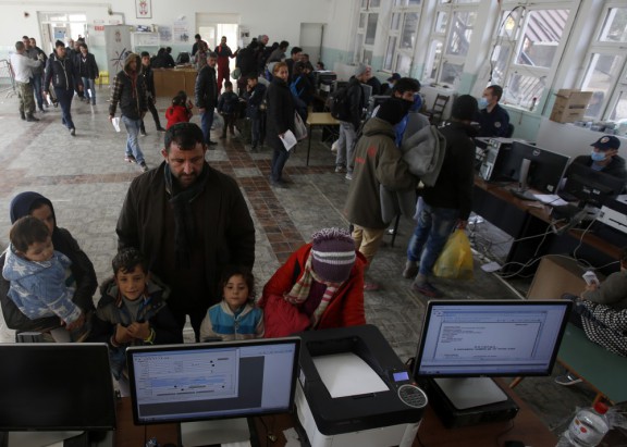 Refugee families wait to register in the Serbian town of Presevo