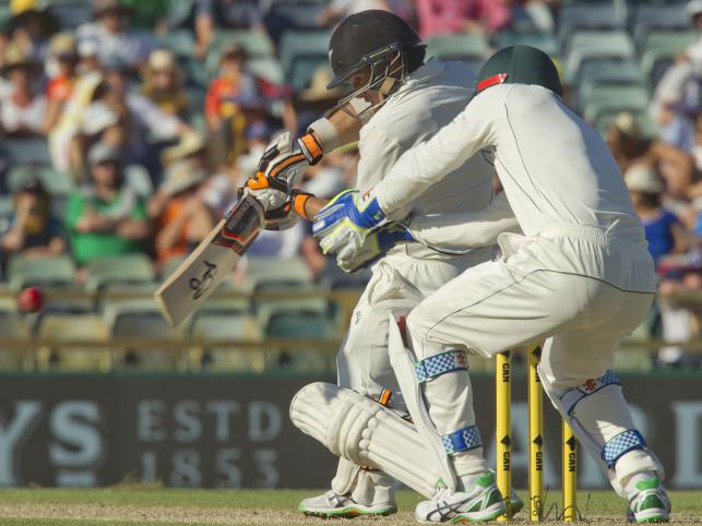 New Zealand`s batsman Tom Latham plays a shot as Australia`s wicketkeeper Peter Nevill fields during day two of the second cricket Test match between Australia and New Zealand in Perth