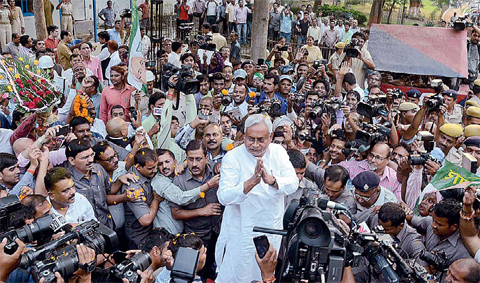 PATNA Bihar Chief Minister Nitish Kumar center is surrounded by media personnel as he greets supporters after victory in Bihar state elections in Patna on Sunday. The alliance led by Kumar defeated Indian Prime Minister Narendra Modi’s ruling Hindu