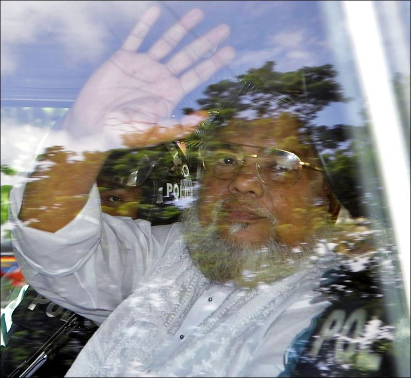 Jamaat-e Islami Secretary General Ali Ahsan Mohammad Mujahid waves from a police vehicle as he is brought to court in Dhaka Bangladesh