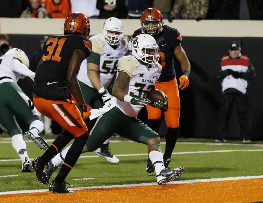 Baylor running back Shock Linwood scores between Oklahoma State safety Tre Flowers and linebacker Seth Jacobs right in the first quarter of an NCAA college football game in Stillwater Okla. Saturday Nov. 21 2015. Pho