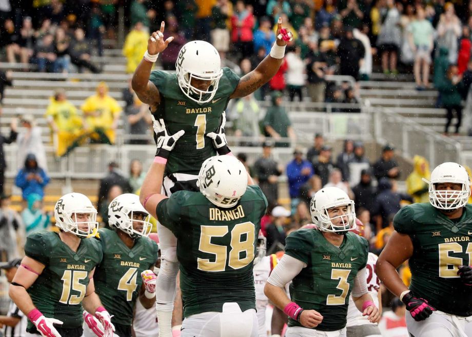 Baylor offensive tackle Spencer Drango lifts wide receiver Corey Coleman after Coleman caught a pass in the end zone for a touchdown in the second half of an NCAA college football game against Iowa State Saturday Oct. 24 2015 in Waco Texas