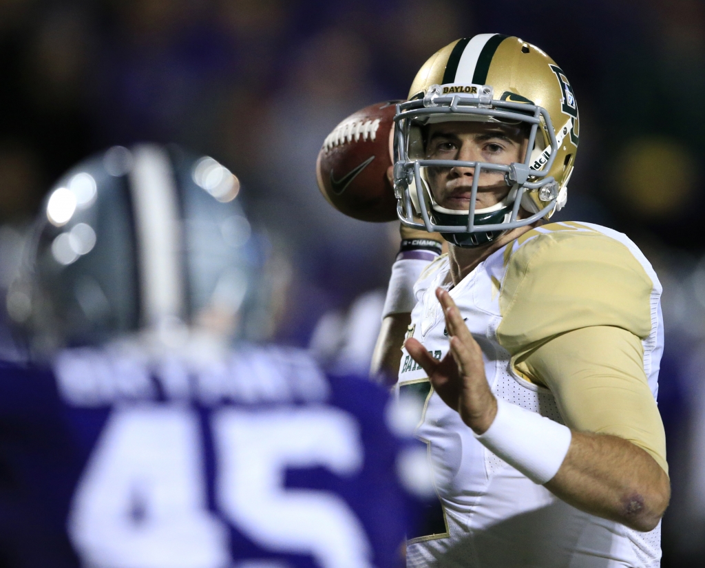 Baylor quarterback Jarrett Stidham right passes to a teammate over Kansas State defensive end Marquel Bryant during the second half of an NCAA college football game in Manhattan Kan. Thursday Nov. 5 2015. Baylor defeated Kansas State 31-24. (AP