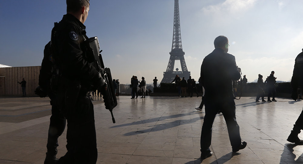 French police officers patrol near the Eiffel Tower in Paris