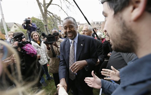 Republican presidential candidate Ben Carson greets audience members after speaking outside the Alpha Gamma Rho fraternity at Iowa State University during a campaign stop in Ames Iowa. Carson and the other Republican presiden